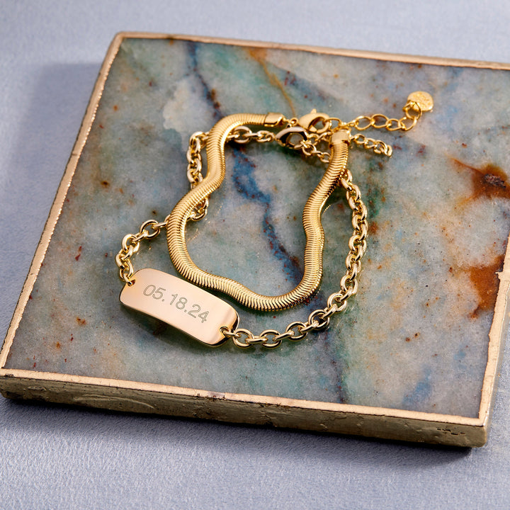 Gold bracelet with a tag on a marble surface