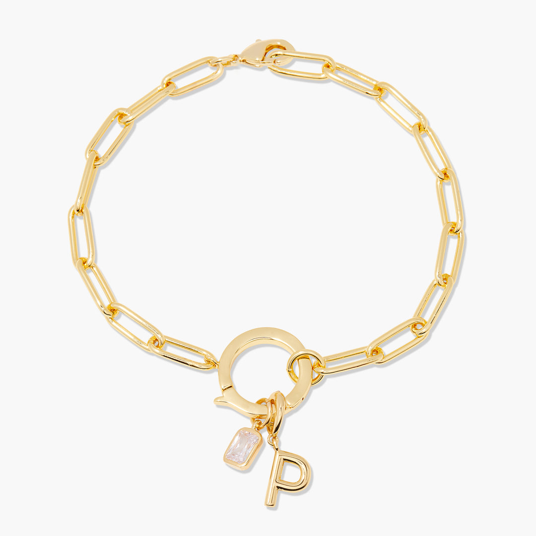 Gold chain bracelet with a 'P' charm on a white background