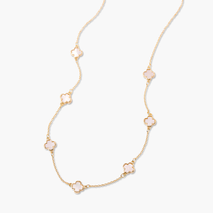 Gold necklace with floral pendants on a white background