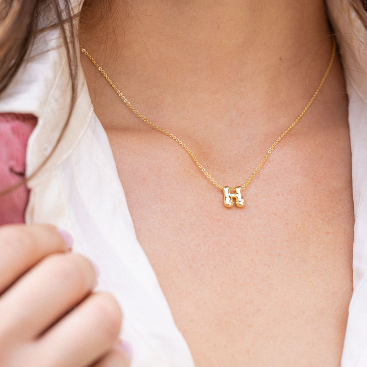 Gold necklace with a letter &