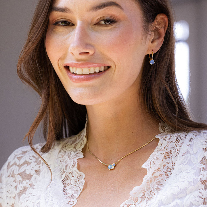 Woman wearing a white lace top with a blurred background
