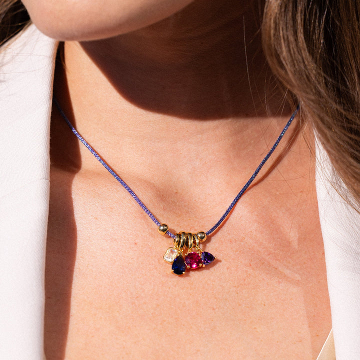 Close-up of a person wearing a colorful necklace with a white background