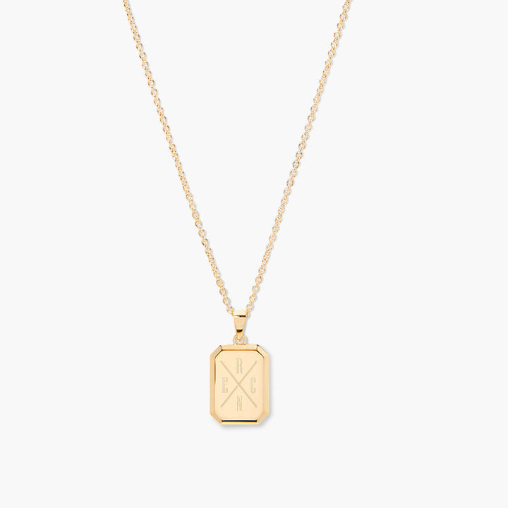 Gold necklace with a rectangular pendant on a white background